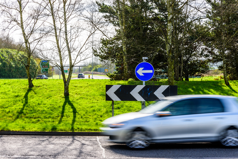Day view of busy traffic on UK Motorway roundabout roundabout